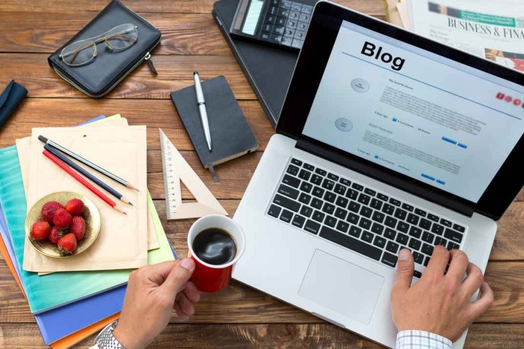 Image of a person working on a blog with a laptop
